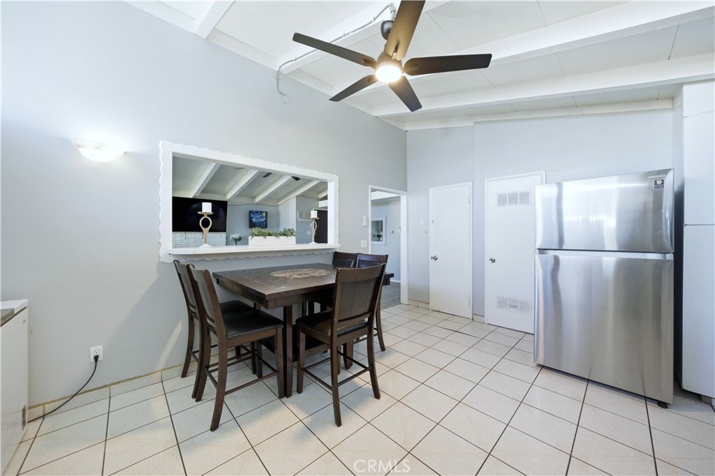10909 1st Whittier, CA 90603 - Photo 12 of 30 a kitchen with stainless steel appliances kitchen island granite countertop a refrigerator a stove a microwave oven with a dining table and chairs