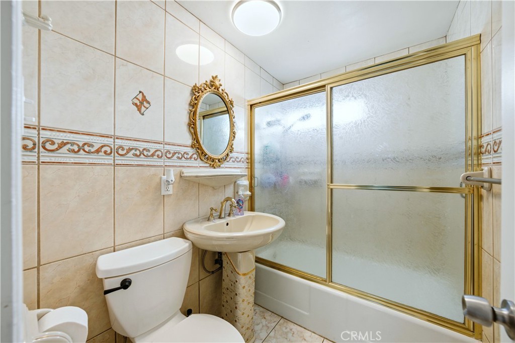 10909 1st Whittier, CA 90603 - Photo 21 of 30 a bathroom with a sink toilet and shower