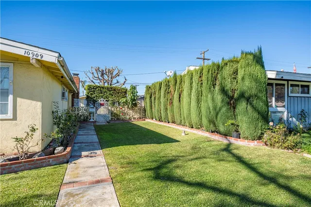 a view of a garden with a building in the background