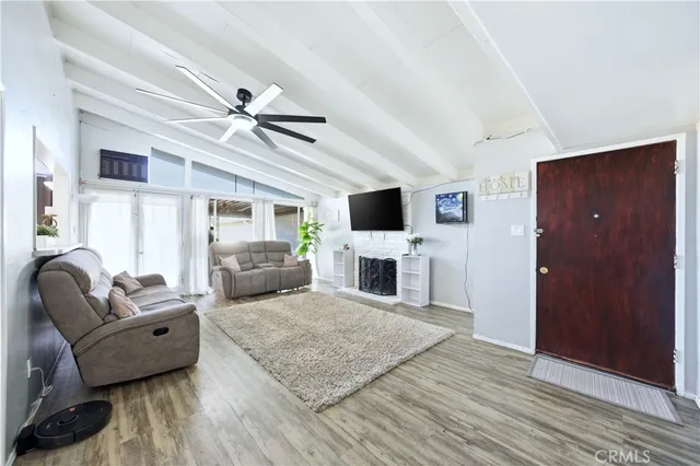 a living room with furniture fireplace and flat screen tv