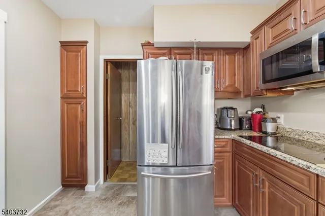 a kitchen with a sink refrigerator and table