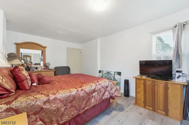 a bedroom with two beds and a chandelier