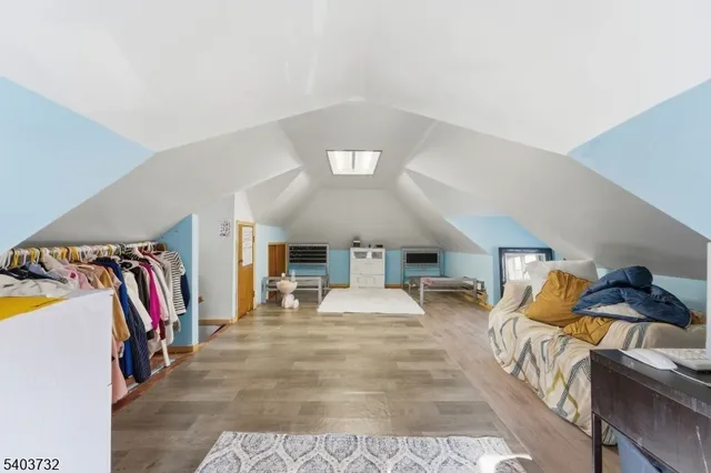 a view of room with hardwood floor and a ceiling fan