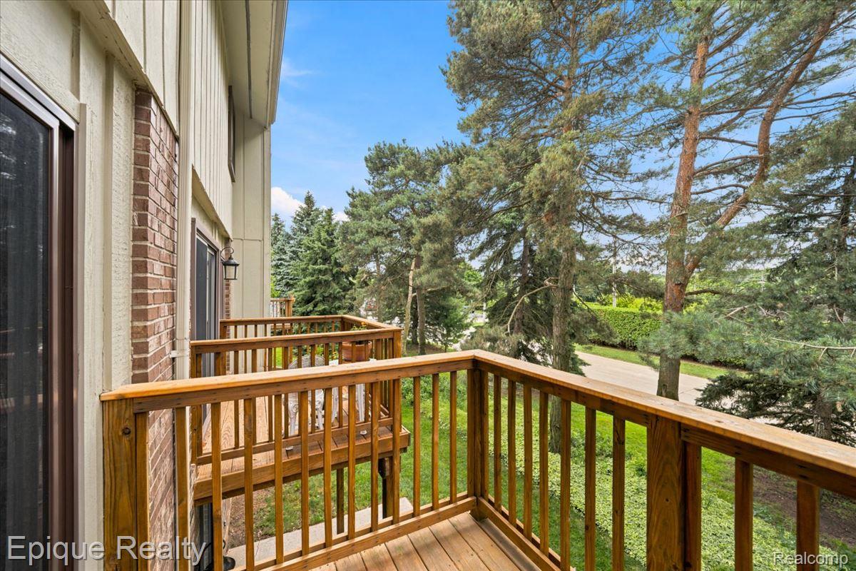 26 Kirks Court Rochester, MI 48309 - Photo 40 of 44 Private wooden balcony featuring a slatted railing and a solid wood exterior door