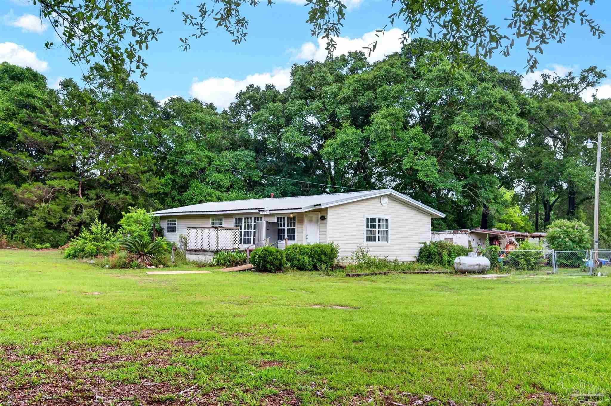 6253 Allentown Road Milton, FL 32570 - Photo 29 of 31 a view of house with yard and green space