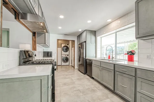 a kitchen with a stove and white cabinets