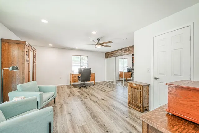 a bedroom with a bed and wooden floor