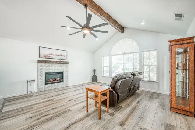a living room with furniture and a wooden floor
