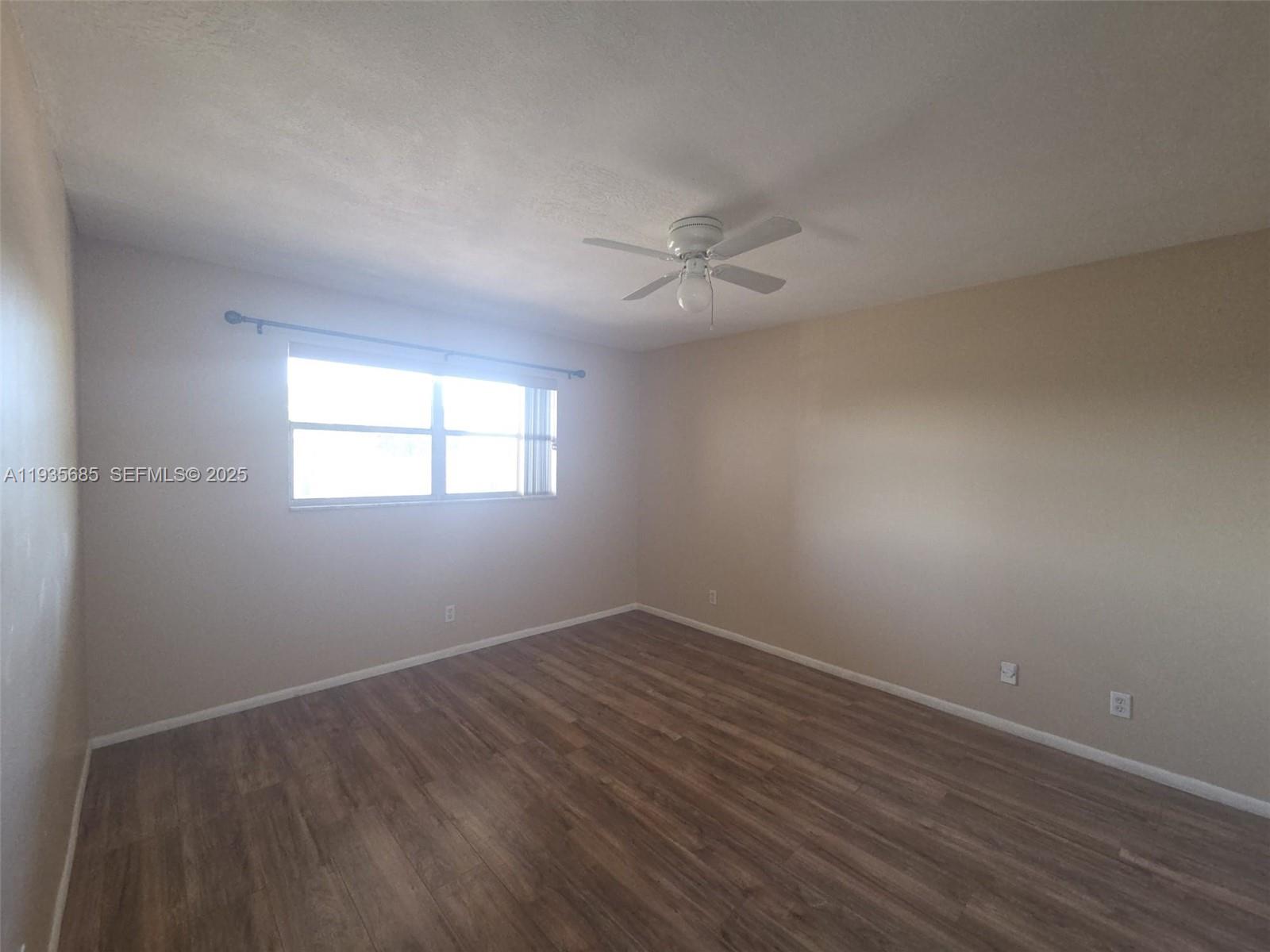 8020 North Colony Circle, Unit 305 Tamarac, FL 33321 - Photo 14 of 19 wooden floor in an empty room with a window