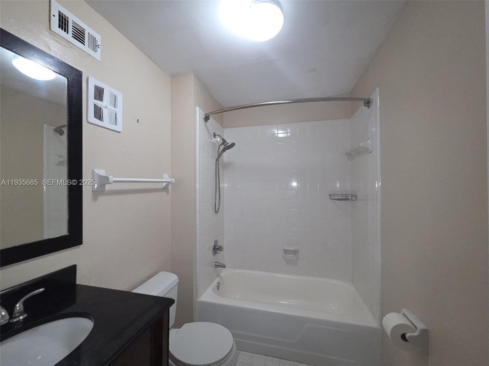 8020 North Colony Circle, Unit 305 Tamarac, FL 33321 - Photo 17 of 19 a bathroom with a sink toilet and shower