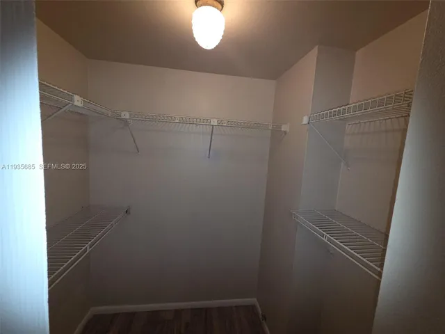 a bathroom with a toilet a sink a mirror and vanity