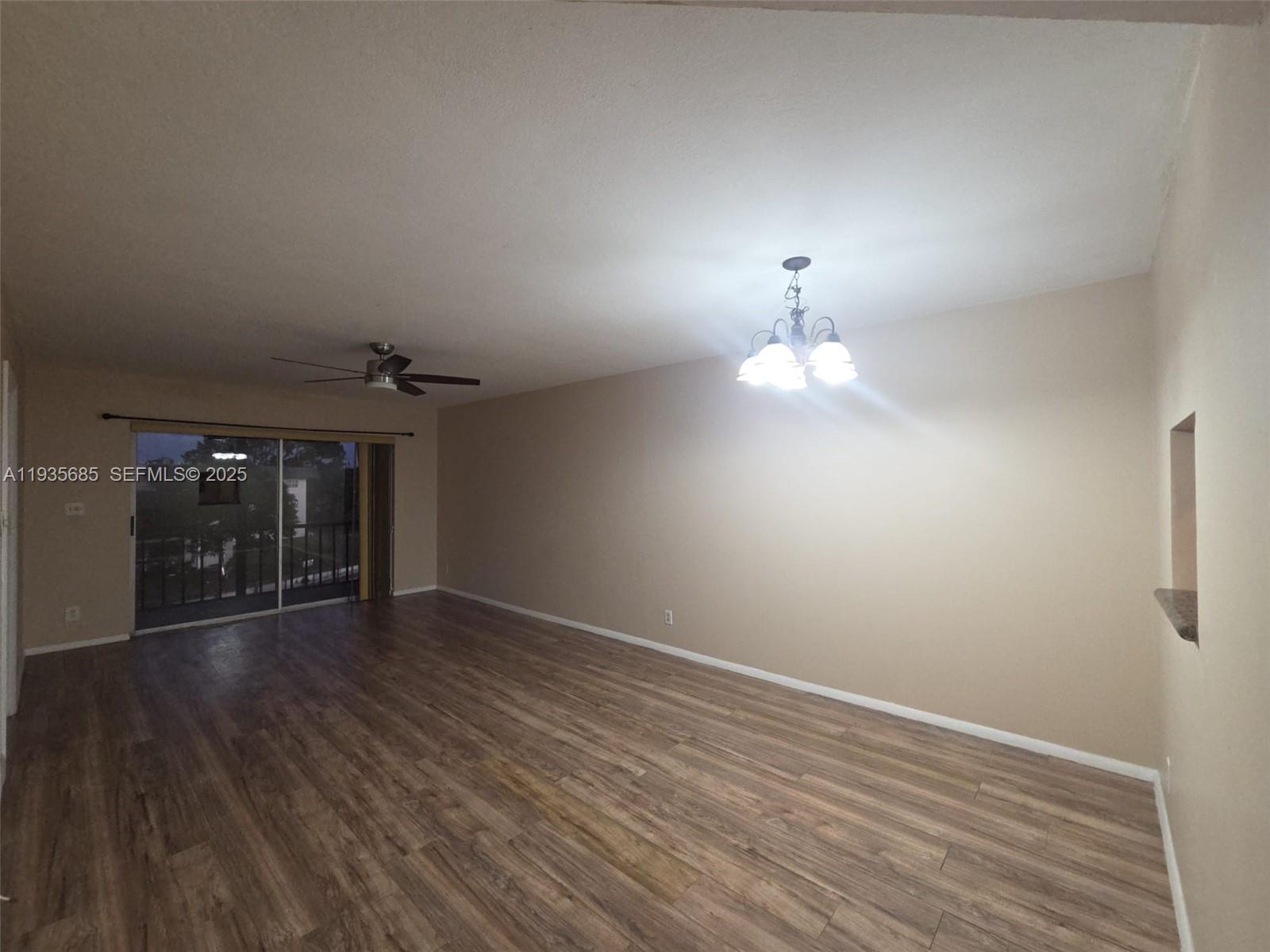 8020 North Colony Circle, Unit 305 Tamarac, FL 33321 - Photo 10 of 19 wooden floor in an empty room with a window