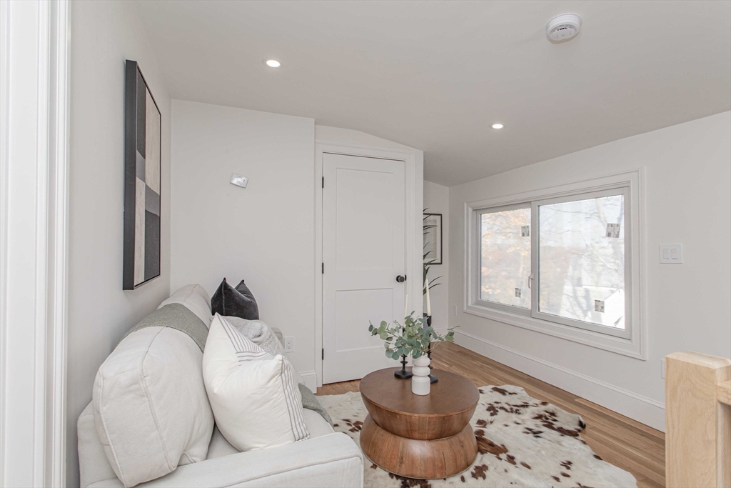 125 Mt Vernon Street, Unit 2 Newton, MA 02465 - Photo 29 of 36 a living room with furniture and a potted plant