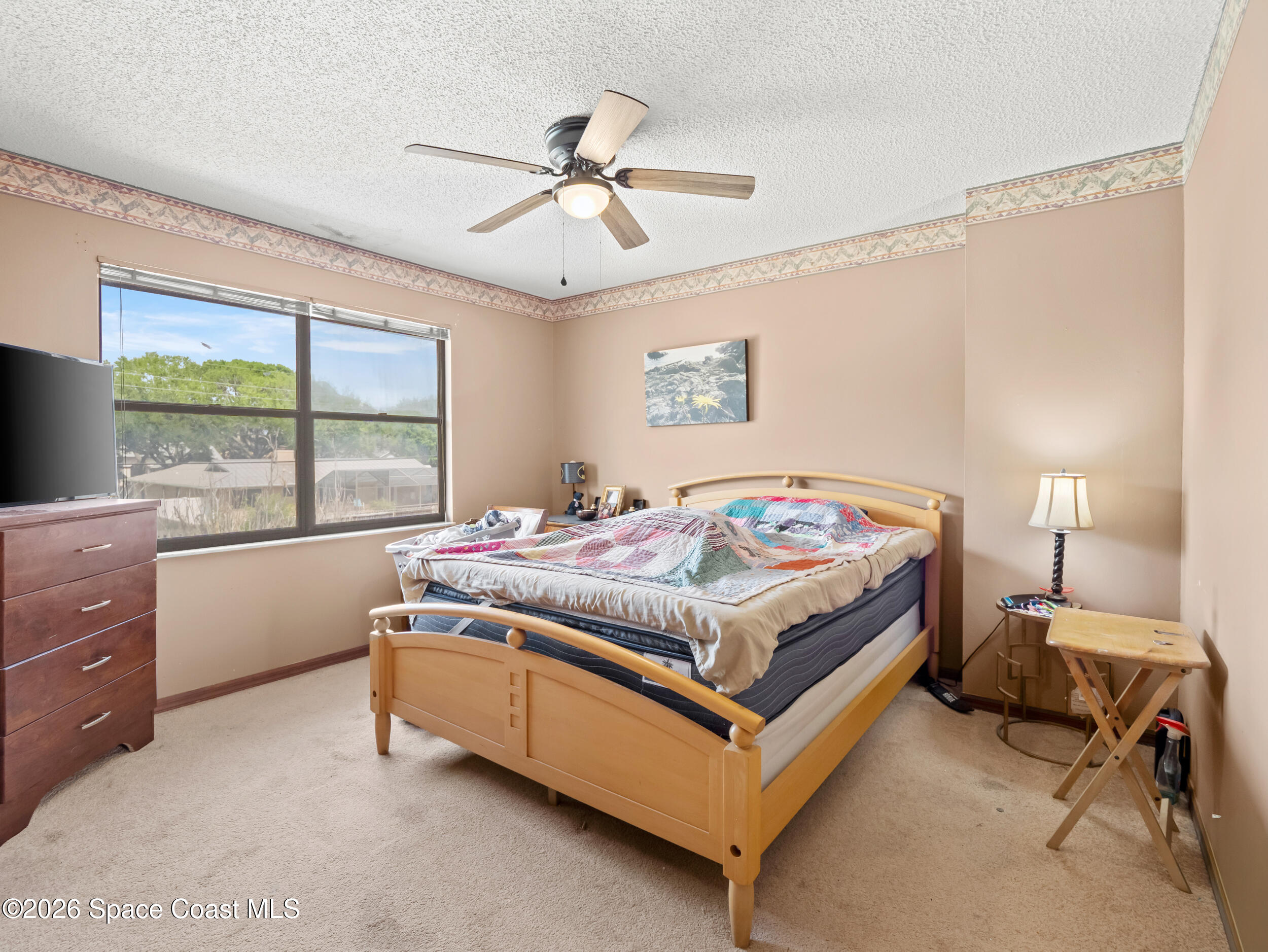 1190 Shady Lane Merritt Island, FL 32952 - Photo 14 of 35 a bedroom with a bed and a window