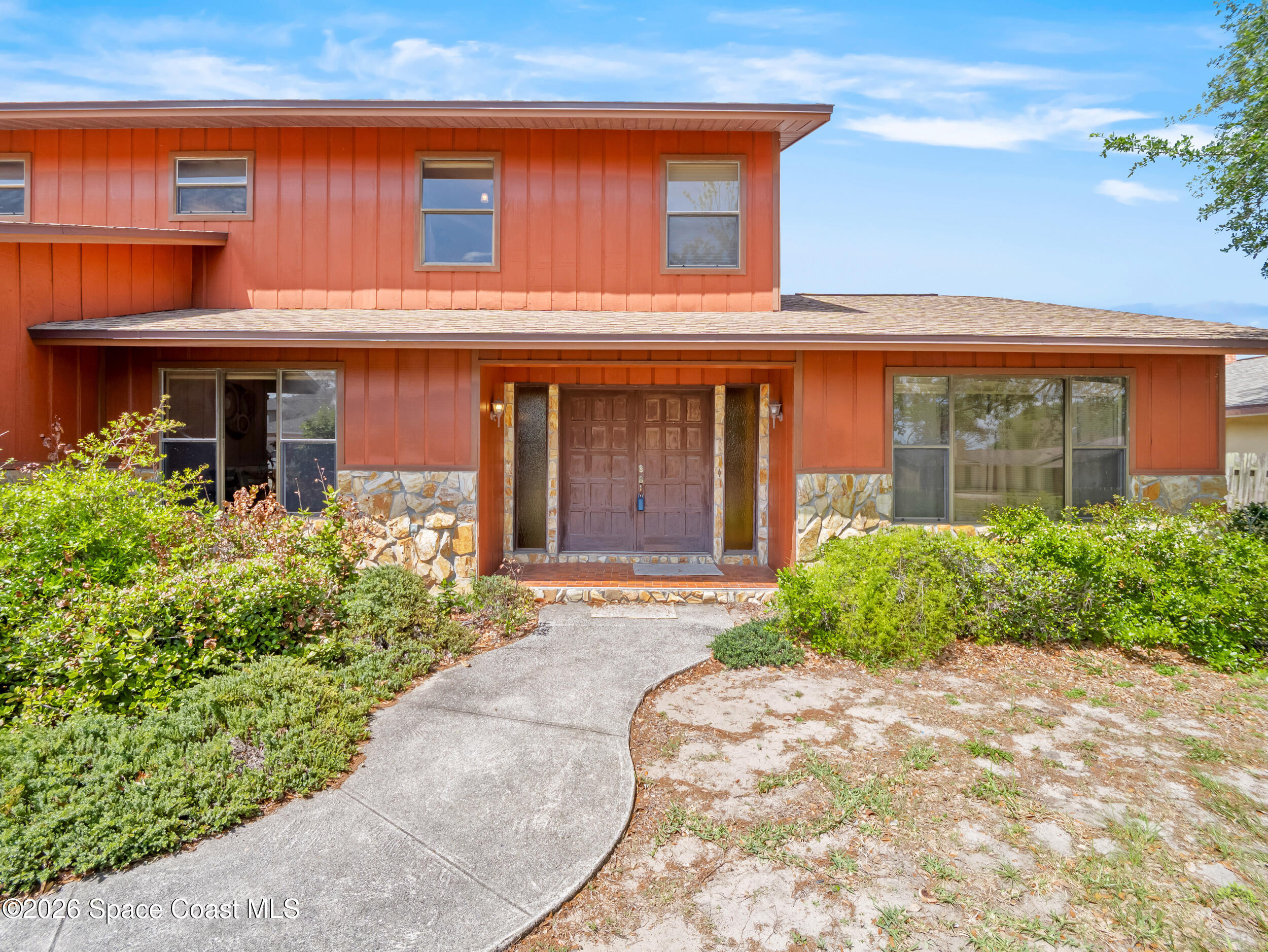 1190 Shady Lane Merritt Island, FL 32952 - Photo 2 of 35 a front view of a house with garden