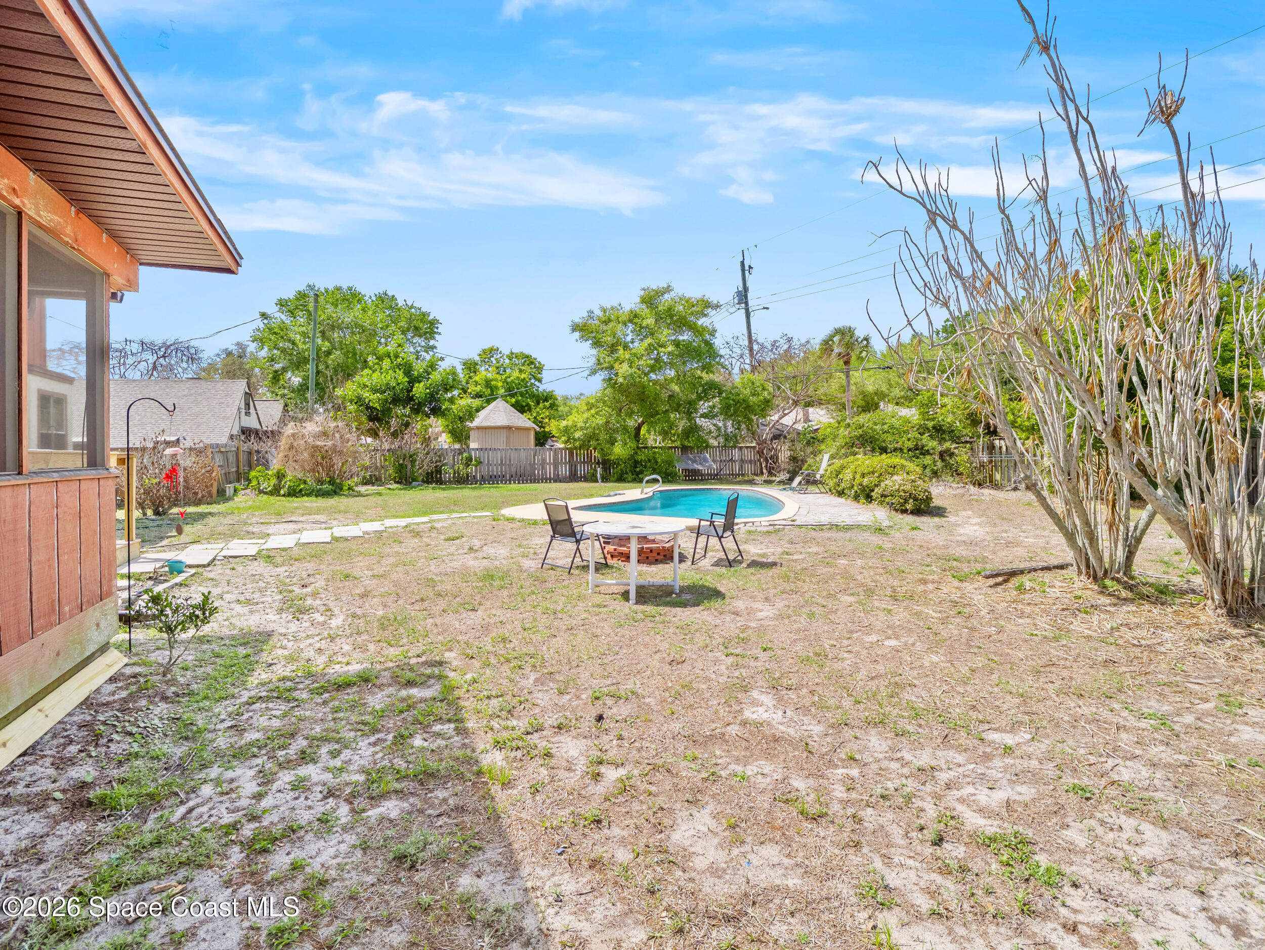 1190 Shady Lane Merritt Island, FL 32952 - Photo 22 of 35 a white bench sitting in the middle of a yard