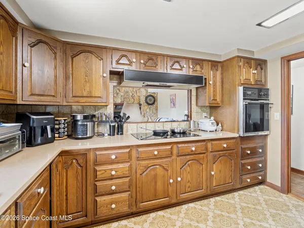 a kitchen with stainless steel appliances granite countertop a sink and cabinets