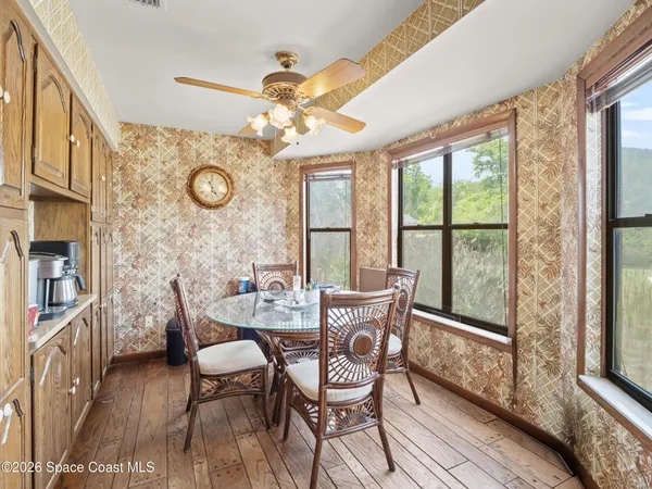 a view of a dining room with furniture window and wooden floor