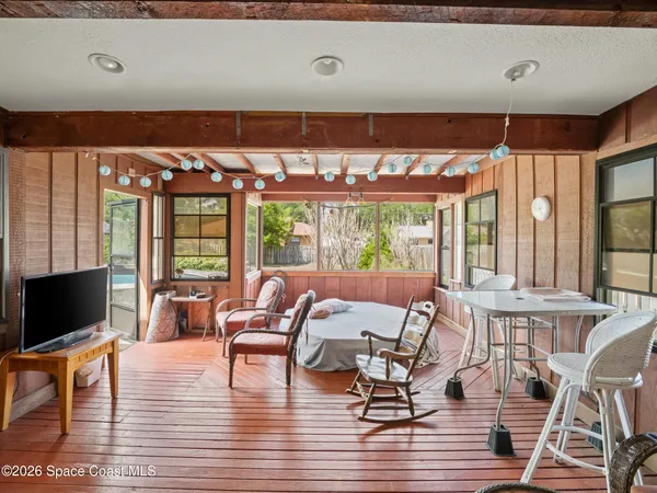 a living room with furniture a large window and a flat screen tv