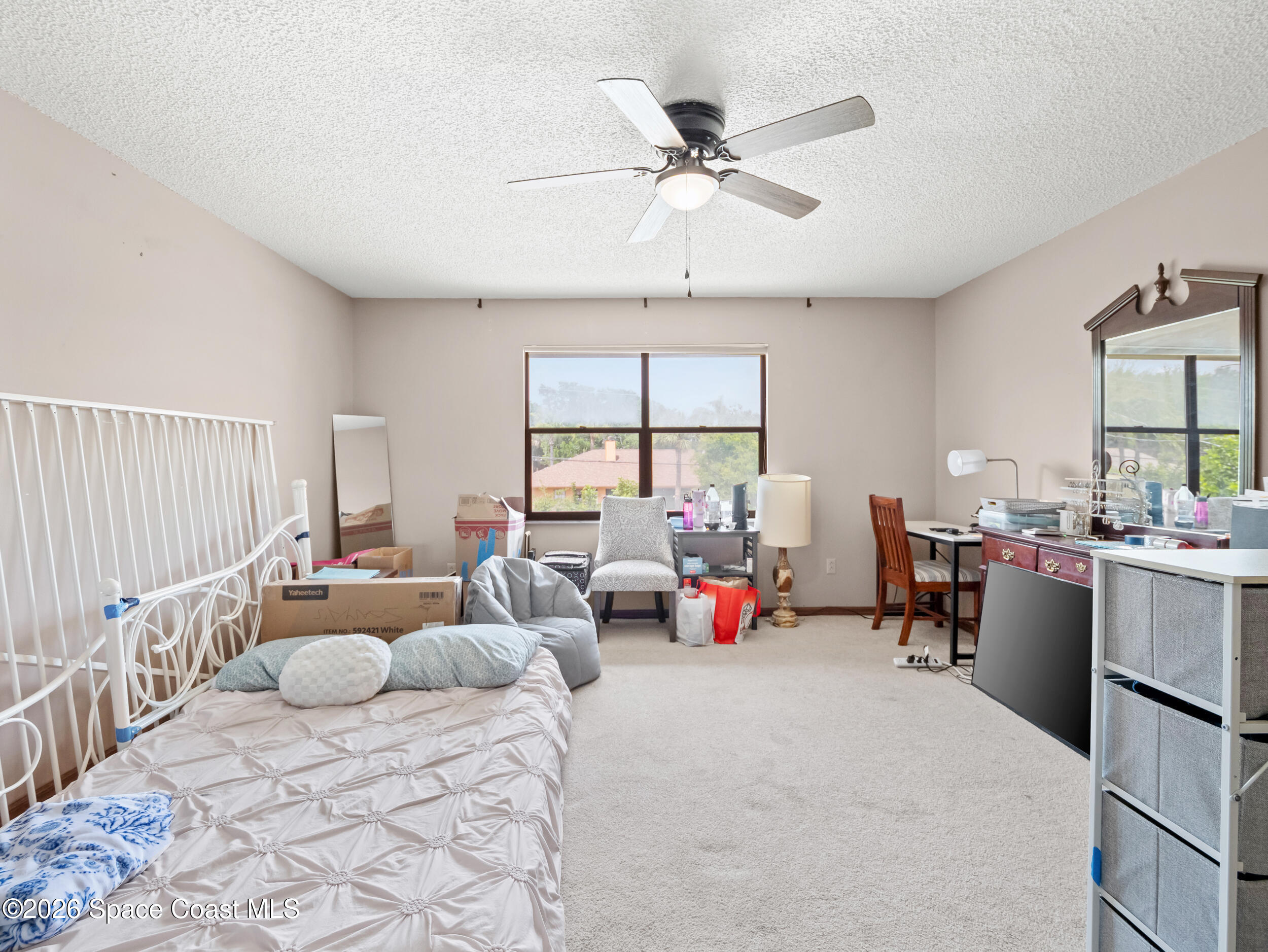 1190 Shady Lane Merritt Island, FL 32952 - Photo 10 of 35 a bedroom with furniture and a large window