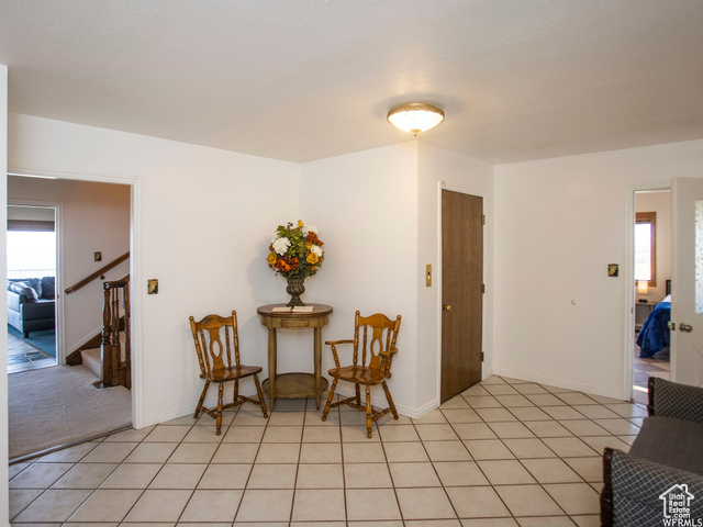 588 Raspberry Patch Road Garden City, UT 84028 - Photo 13 of 74 Living area featuring healthy amount of natural light, stairs, and light tile patterned flooring