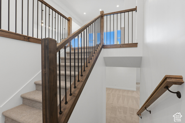 538 North Legend Circle, Unit 505 Mapleton, UT 84664 - Photo 37 of 48 Staircase featuring wood railings with black balusters, carpeted treads, and a recessed ceiling light
