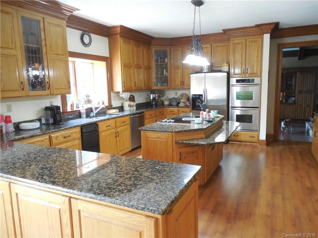 930 Shive Road Salisbury, NC 28146 - Photo 13 of 36 a kitchen with sink refrigerator and cabinets