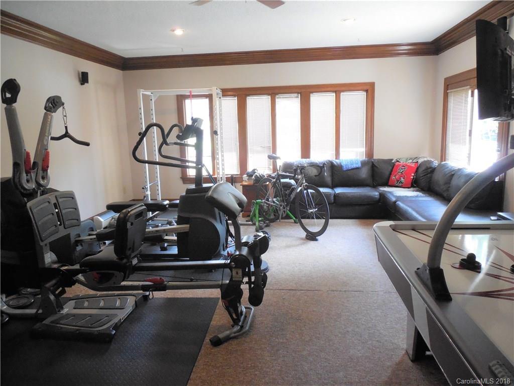 930 Shive Road Salisbury, NC 28146 - Photo 20 of 36 a living room with furniture gym equipment and a large window