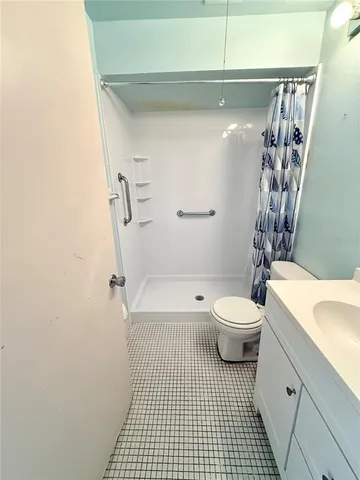 a bathroom with a toilet a sink and a shower