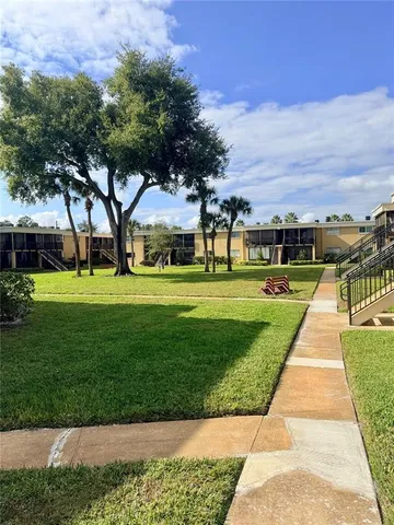 a front view of a building with a garden