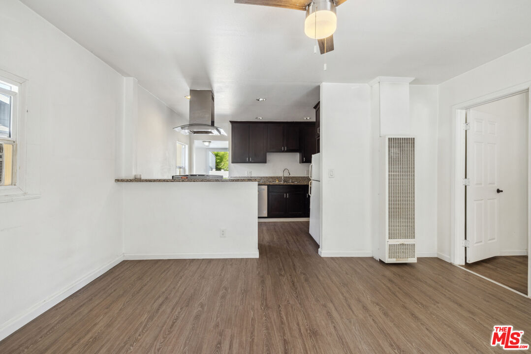 3110 Pyrites Street Los Angeles, CA 90032 - Photo 12 of 30 a kitchen with wooden floors and white cabinets