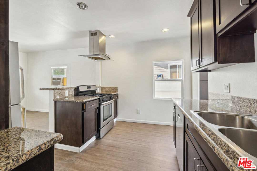 3110 Pyrites Street Los Angeles, CA 90032 - Photo 18 of 30 a kitchen with stainless steel appliances granite countertop a sink a stove and a refrigerator
