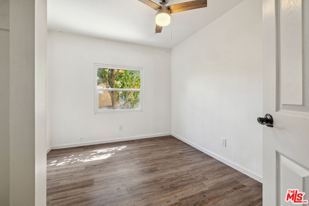 3110 Pyrites Street Los Angeles, CA 90032 - Photo 22 of 30 an empty room with wooden floor fan and windows