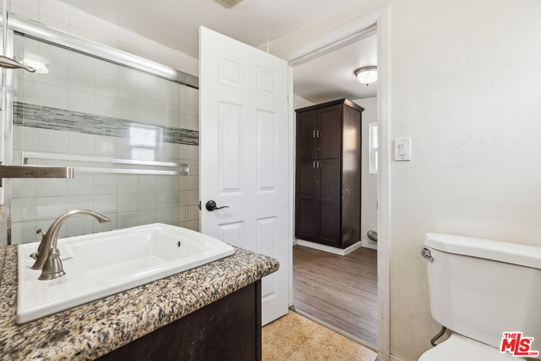 3110 Pyrites Street Los Angeles, CA 90032 - Photo 24 of 30 a bathroom with a granite countertop sink and toilet