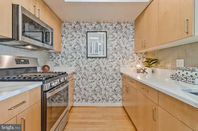 a spacious bathroom with a granite countertop sink a mirror and a shower