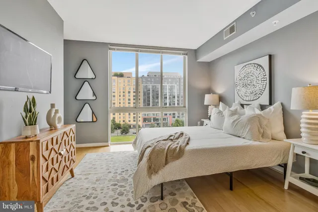 a bedroom with a bed and a lamp on table