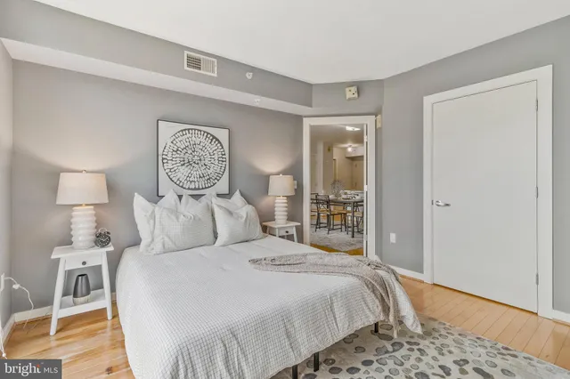 a bedroom with bed and flat screen tv