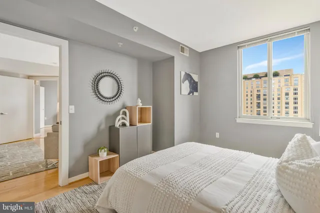 a bedroom with a bed and painting on the wall