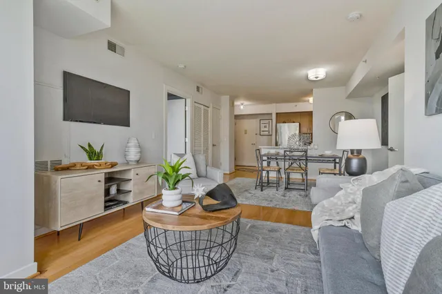 a dining room with furniture window and wooden floor