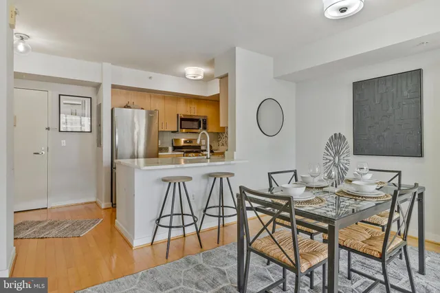 a kitchen with stainless steel appliances a refrigerator sink and white cabinets