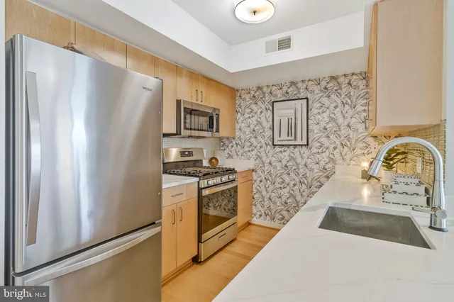 a bathroom with a sink a mirror and a shower