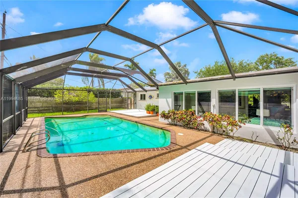 a view of a house with backyard sitting area and garden