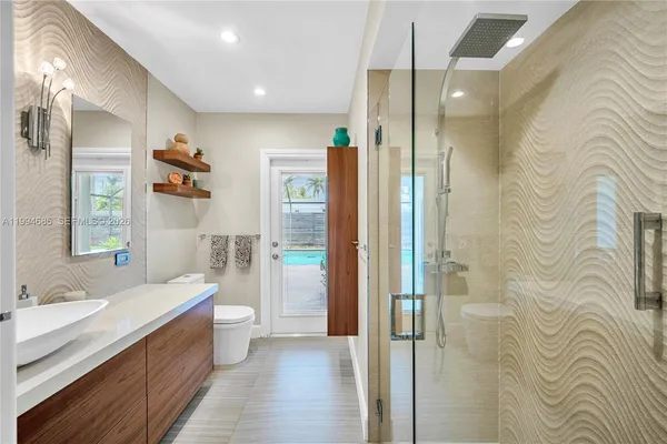 a bathroom with a double vanity sink toilet and shower
