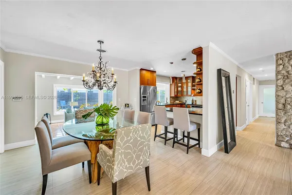 a view of a dining room with furniture and chandelier