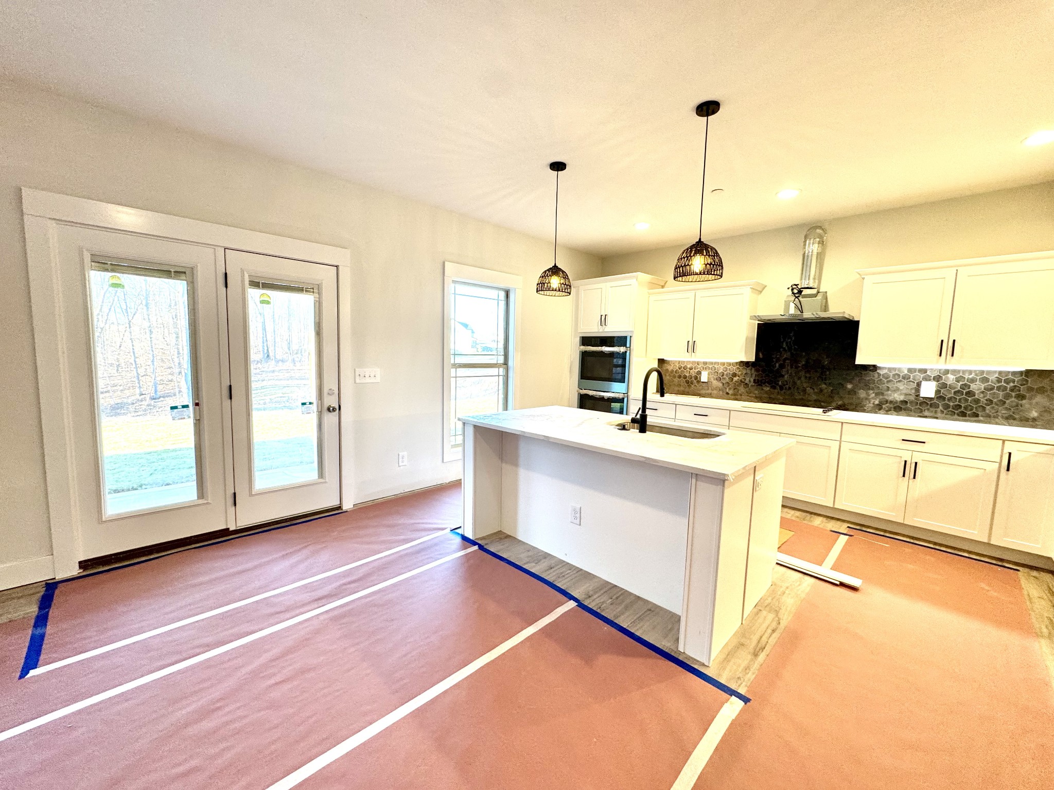 406 Young Lane Pleasant View, TN 37146 - Photo 19 of 60 a kitchen with stainless steel appliances kitchen island granite countertop a stove a sink and white cabinets with wooden floor