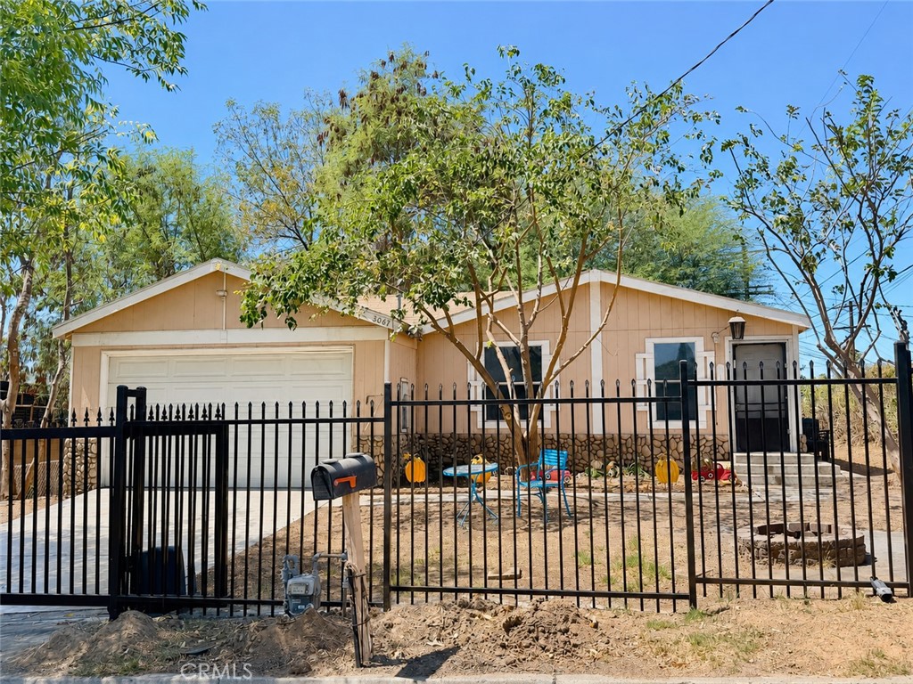 3067 Carl Street Riverside, CA 92507 - Photo 5 of 23 stunning front exterior showcasing the home's inviting curb appeal and gated frontage for added privacy and security.