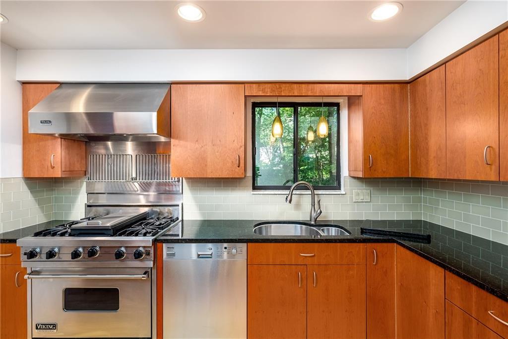124 Berwyn Road Pittsburgh, PA 15237 - Photo 8 of 25 a kitchen with stainless steel appliances granite countertop a sink a stove and a microwave