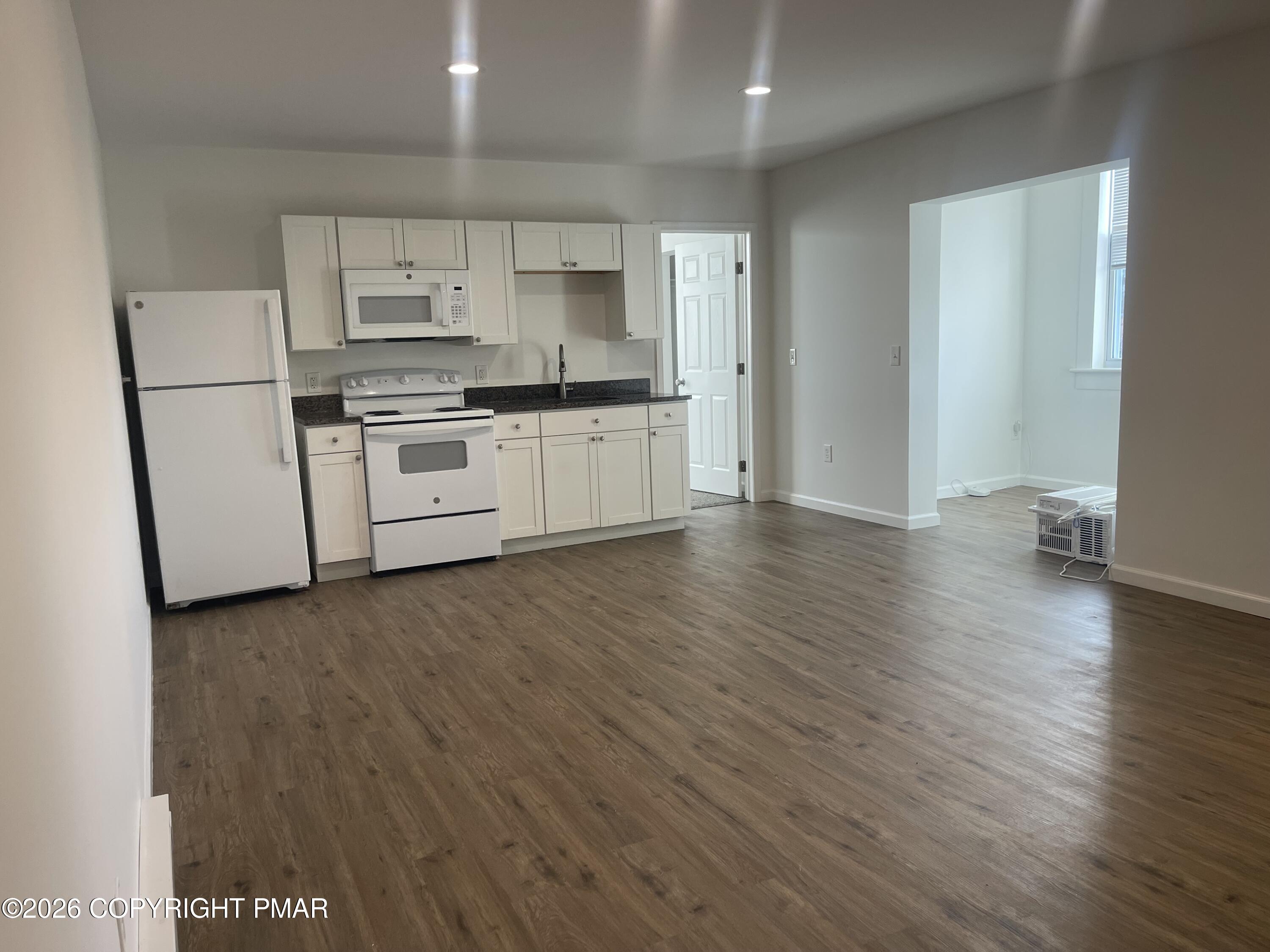 548 Main Street, Unit 6B Stroudsburg, PA 18360 - Photo 6 of 16 a kitchen with stainless steel appliances a refrigerator sink and cabinets