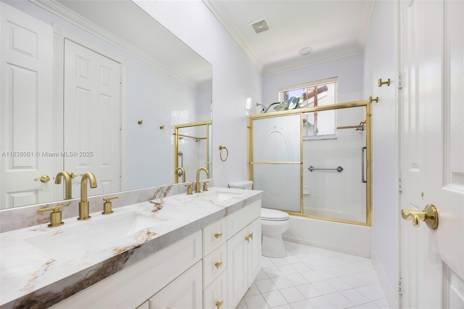 1571 Breakwater Terrace Hollywood, FL 33019 - Photo 19 of 42 a bathroom with a sink a toilet and shower