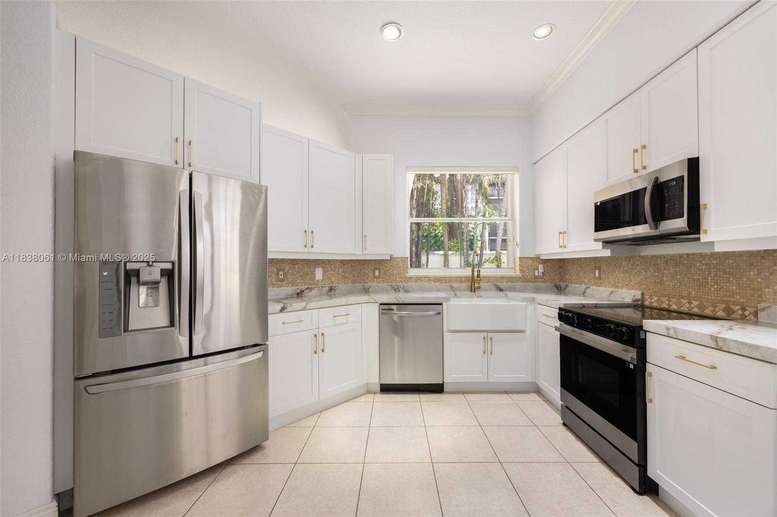 1571 Breakwater Terrace Hollywood, FL 33019 - Photo 10 of 42 a kitchen with a refrigerator stove microwave and sink